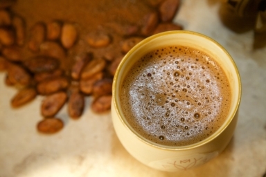 Cacao Elixir In Mug With Cocoa Beans And Chocolate Powder